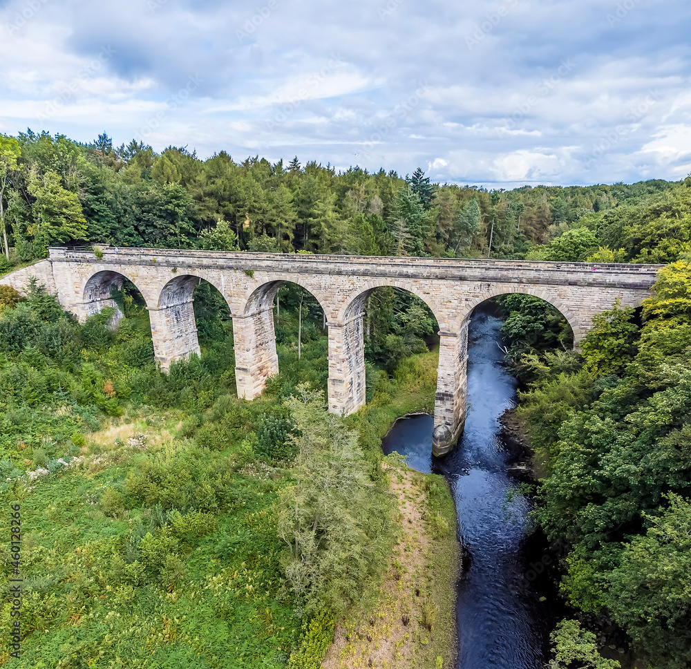 A view along the River Nidd towards the Nidd Gorge Viaduct near to Knaresborough in Yorkshire, UK in summertime