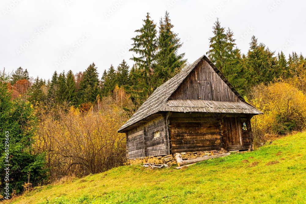Old house in a small valley with green meadows and colorful forests Old house in a small valley with green meadows and colorful forests