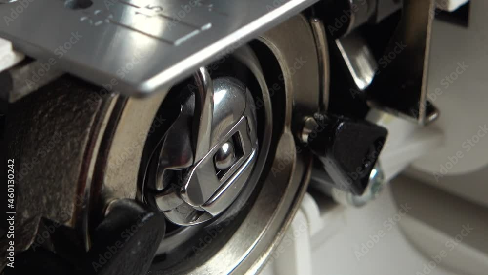 The needle of a sewing machine makes a thread stitch. Elements of the