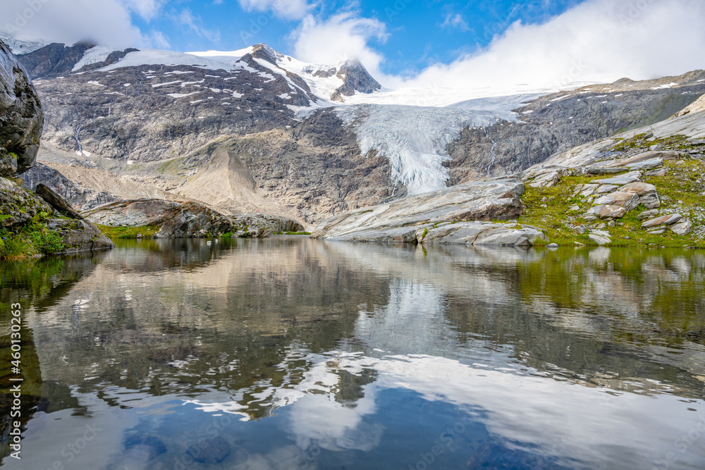 Mountain Glacier in alpine valley reflected in water. Schlaten Glacier, German: Schlatenkees, Hohe Tauern National Park, East Tyrol, Austrian Alps