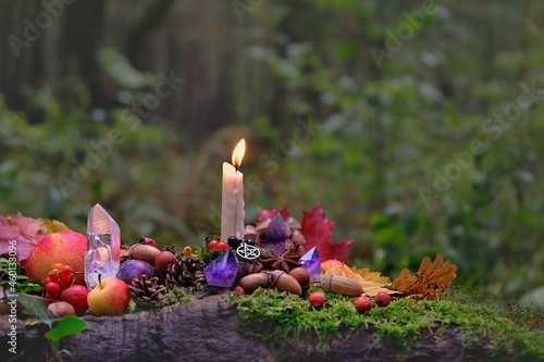 Bild auf Leinwand Candle, gemstones, fruits and nuts on natural forest background
