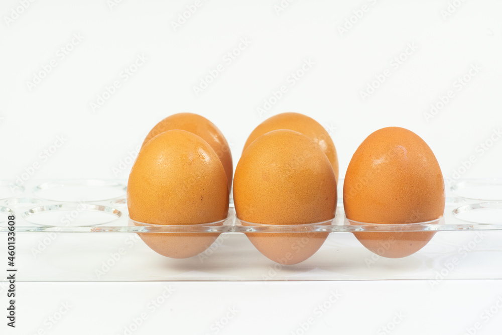 Closed up the eggs at clear tray on white background Closed up the eggs at clear tray on white background