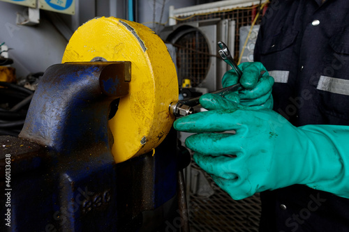 Worker install Tightening Tube Fittings of gas flow rate controller by wrench . In the oil and gas industrial plant.