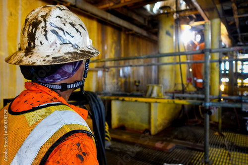 Fire watcher watch welder weld gas pipe casing for stop work in case of gas explosive, working in offshore oil and gas platform rig.