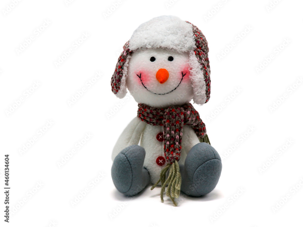 Funny snowman in a winter knitted hat and scarf with a carrot nose. Cute stuffed animal. New year gift. Christmas attribute. Christmas collection. Snowman.