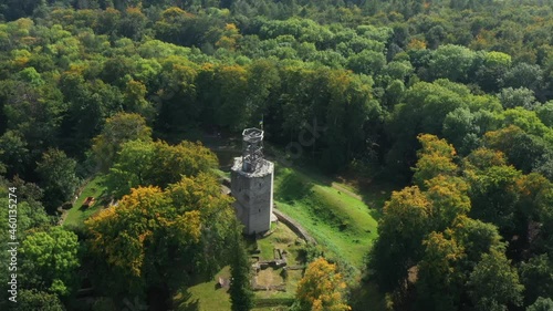 Aerial view with an overview of a dense forest area and a ruined tower from the 12th century with polished defensive walls photo