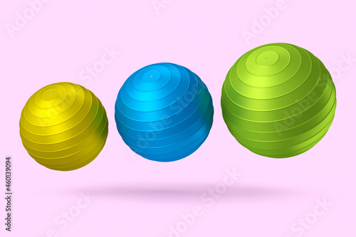 Multicolor fitball or fitness ball for yoga exercise isolated pink background