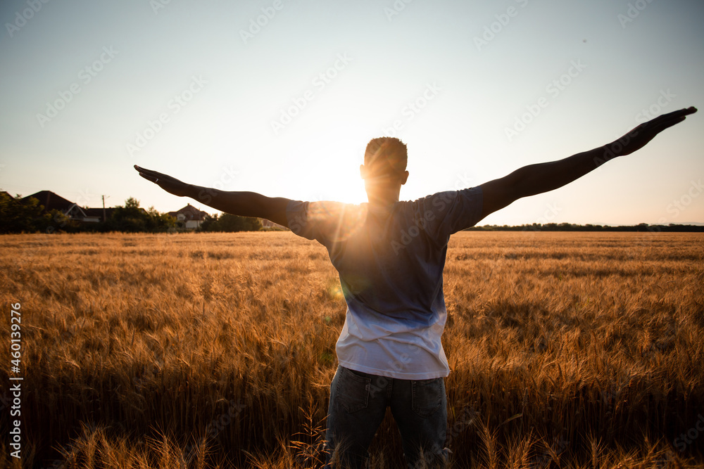 Unspecified man with hands up watching sunset Unspecified man with hands up watching sunset