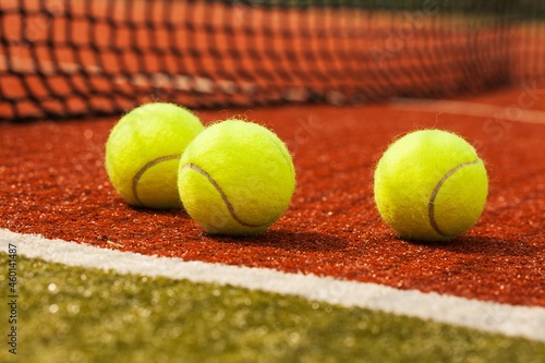 Tennis balls on a red clay court © BillionPhotos.com