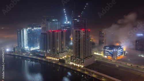 Buildings are covered in thick layer of fog in Business Bay night timelapse.