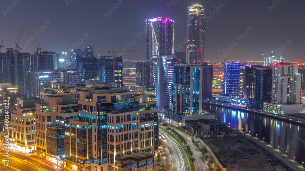 Skyscrapers at the Business Bay aerial all night timelapse in Dubai, United Arab Emirates