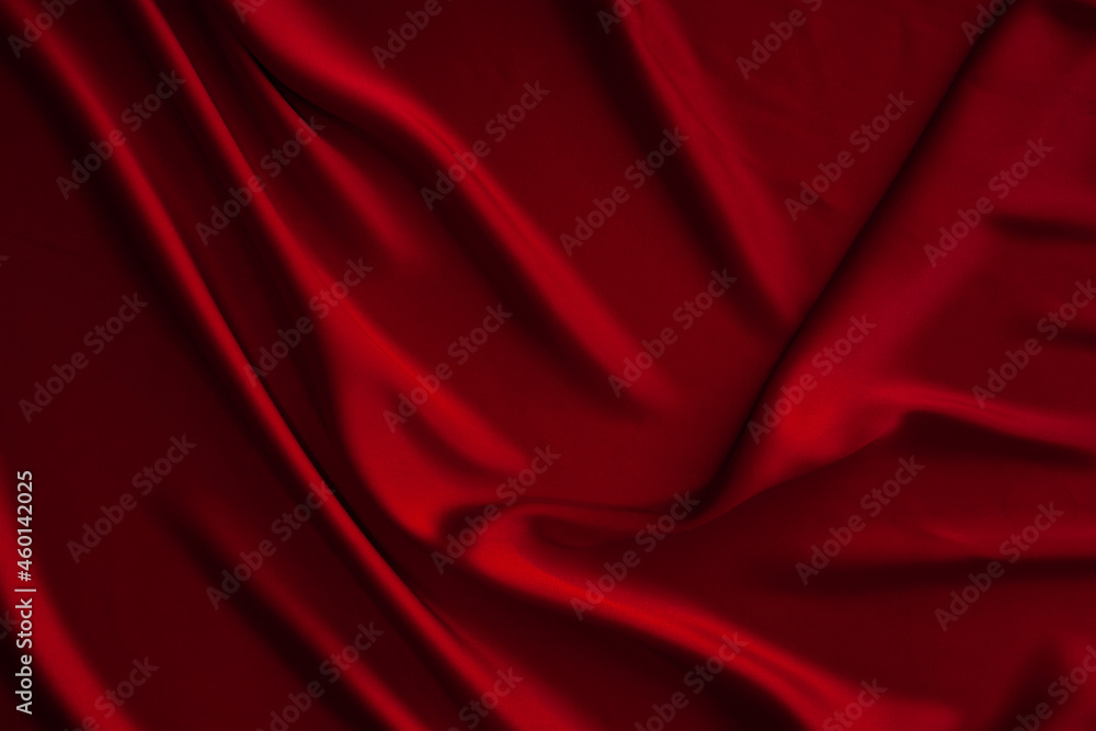 Red fabric texture background. Silk satin folds