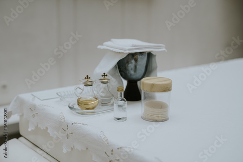 Beautiful shot of religious appliances on a white table preparing for a baptism photo