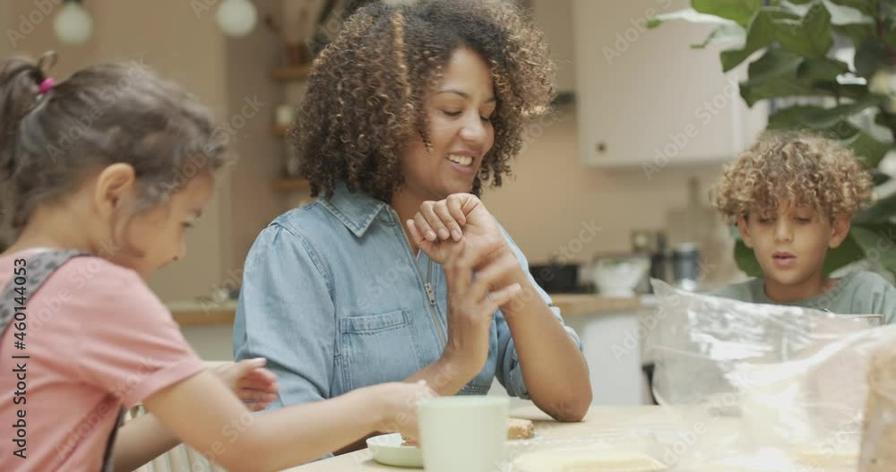 Mother teaching daughter to make a sandwich