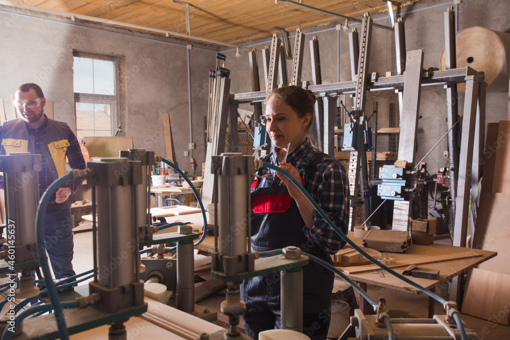 Cheerful female production operator in blue coverall Cheerful female production operator in blue coverall