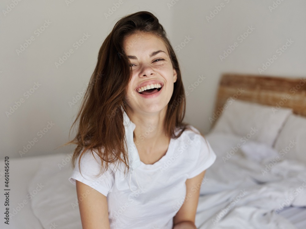 happy woman indoors with medical mask on her face laughing emotions positive happy woman indoors with medical mask on her face laughing emotions positive