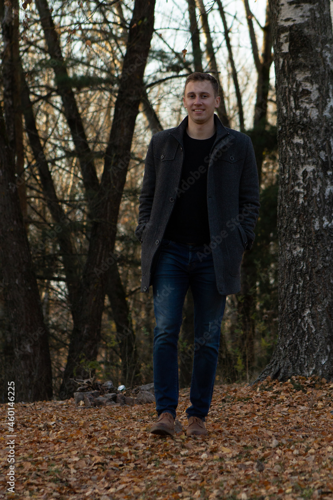 a man walking in the autumn forest