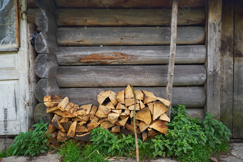 Chopped firewood for the winter near a wooden house