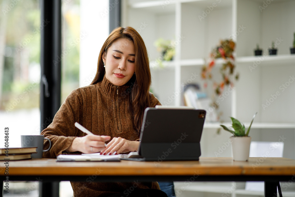 Professional young asian business woman using computer laptop and Talking On Phone Working On Laptop In Modern Office. Professional young asian business woman using computer laptop and Talking On Phone Working On Laptop In Modern Office.