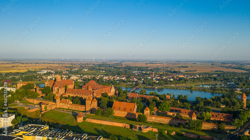 Malbork,Poland. Aerial photo from drone to Medieval Malbork ( Zamek w Maborku, Ordensburg Marienburg ),castle in Poland fortress of the Teutonic Knights at the Nogat river in sunrise light.(Series)