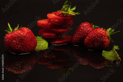 Fresh ripe red strawberries isolated on black background. Creative food concept
