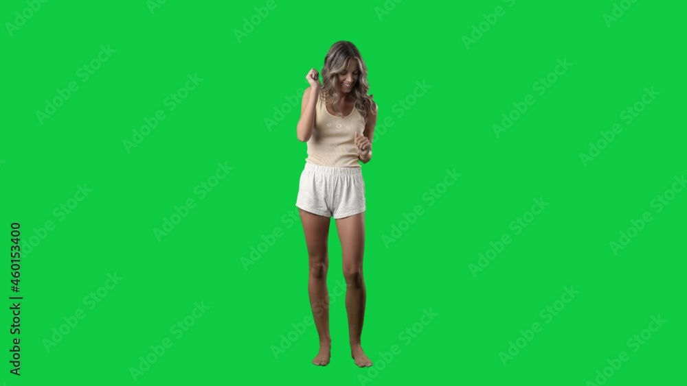 Slow motion of dancing young woman in cozy pajamas relaxing. Full body on green screen chroma key background Slow motion of dancing young woman in cozy pajamas relaxing. Full body on green screen chroma key background