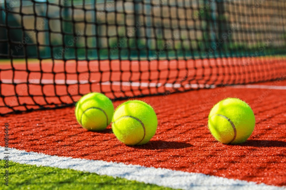 Tennis balls on a red clay court