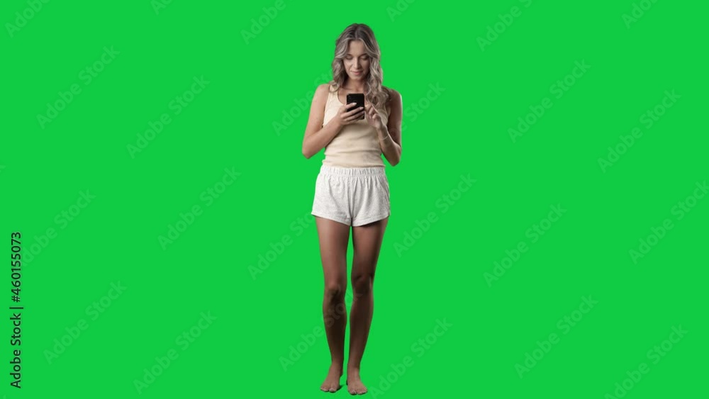 Woman in pajamas using phone with various reactions and expressions. Full body on green screen chroma key background Woman in pajamas using phone with various reactions and expressions. Full body on green screen chroma key background