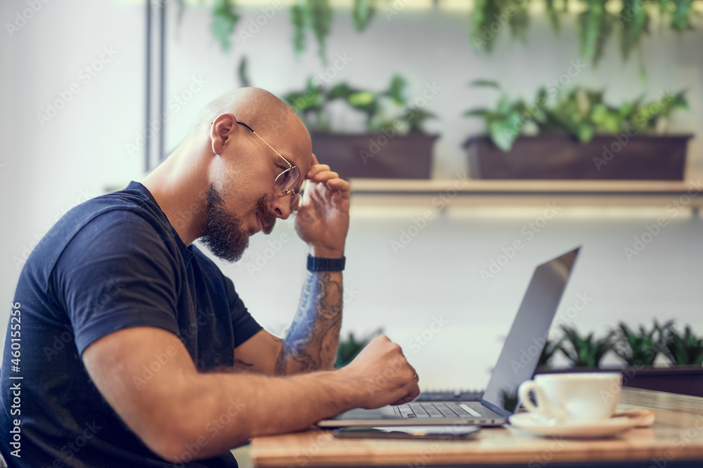 Millennial caucasian man works on computer at home office. Distance Job Millennial caucasian man works on computer at home office. Distance Job