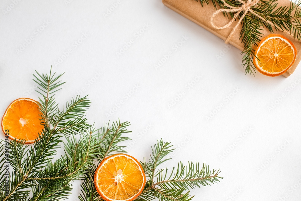 Eco friendly composition with gift boxes in craft reusable paper, fir tree and oranges decor on white background. Holiday zero waste  concept.