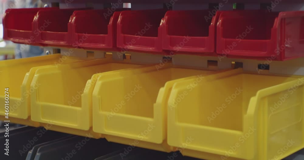 identical plastic boxes are on the shelves in the warehouse.close-up. identical plastic boxes are on the shelves in the warehouse.close-up.