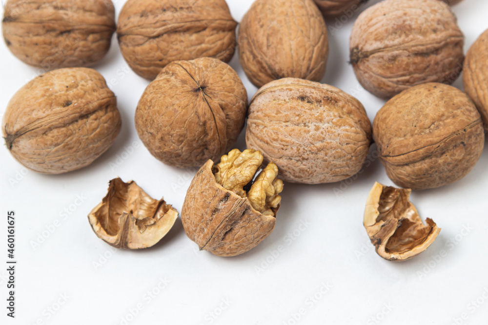 Walnuts on a white background. Chopped walnut. Walnuts on a white background. Chopped walnut.
