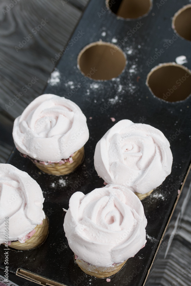 Homemade marshmallows. Marshmallow in a waffle cone on a counter for making. Made in the shape of a rose. Close-up shot. Homemade marshmallows. Marshmallow in a waffle cone on a counter for making. Made in the shape of a rose. Close-up shot.