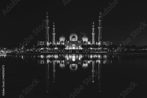 Famous Grand Mosque in Abu Dhabi, United Arab Emirates at night with a reflection in the pool in black and white