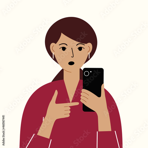 Angry woman with mobile phone, front view. Indicates the phone. News. Smartphone and internet addiction.