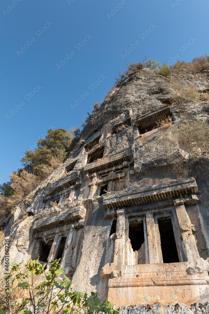 Tomb of Amyntas,  the Fethiye Tomb. View of the tombs carved into the rock from the time of the ancient state of Lycia. Amyntas ancient Lycian rock tombs in Pinara, Fethiye - Turkey