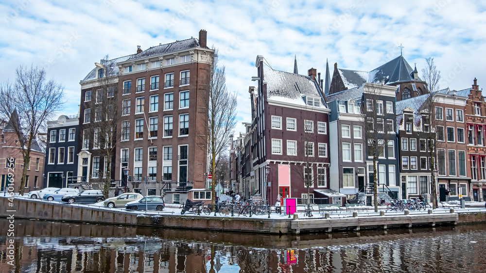 City scenic from snowy Amsterdam in winter in the Netherlands