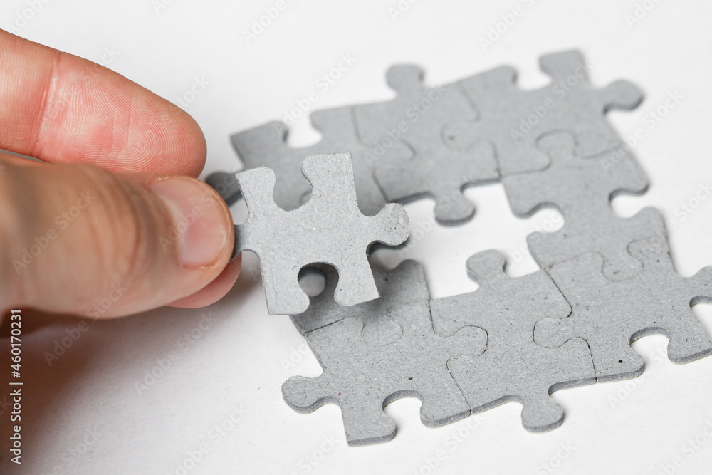 Person adding last piece of jigsaw puzzle Person adding last piece of jigsaw puzzle