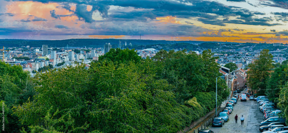 HDR Panorama with an amazing view over the Belgium city of Liege during a colourful sunset and in the background a dramatic sky with clouds full of heavy rain.