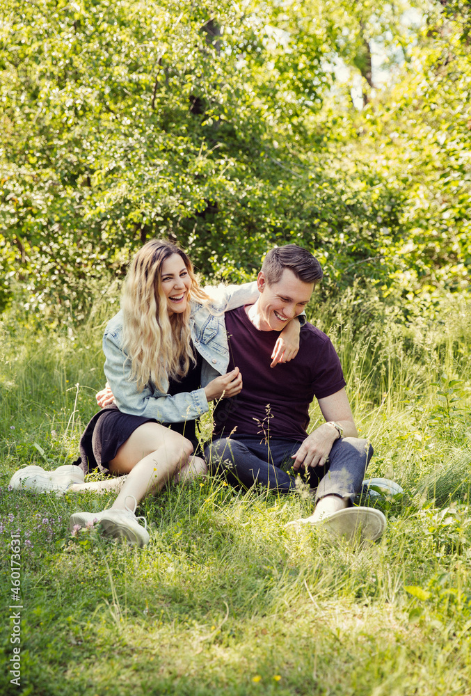 Austria, Vienna, Smiling young couple flirting in park Austria, Vienna, Smiling young couple flirting in park