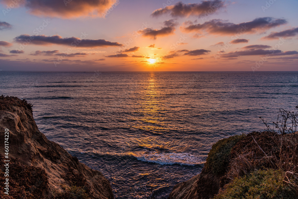 Vibrant sunset over the Pacific Ocean from the cliffs of a beach in San Diego California