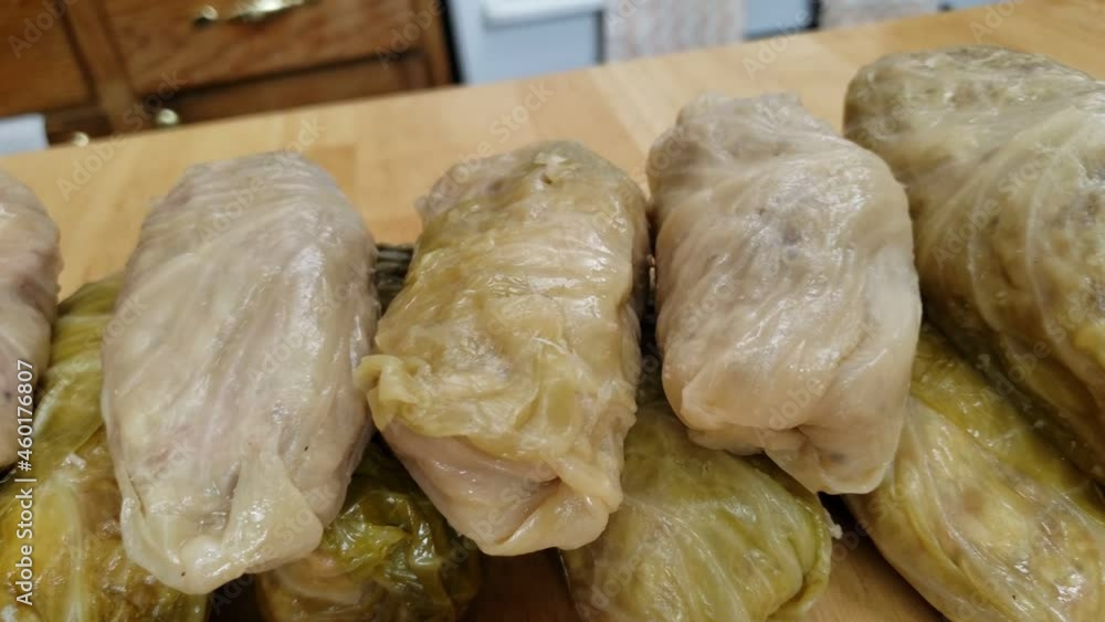Home cooking - Panning left to right of pile of cooked or steamed cabbage rolls with meat stuffing. Home cooking - Panning left to right of pile of cooked or steamed cabbage rolls with meat stuffing.