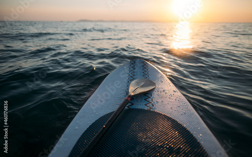 Bild auf Leinwand Paddleboard with paddle on sunset sea