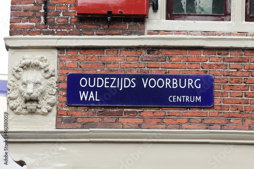 Amsterdam Oudezijds Voorburgwal Street Name Sign with Sculpted Lion Head Detail, Netherlands photo