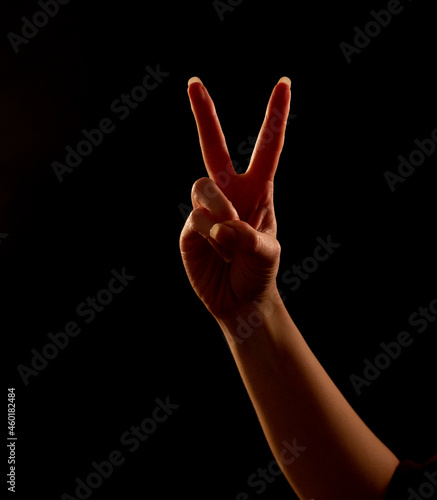 woman holding two fingers up