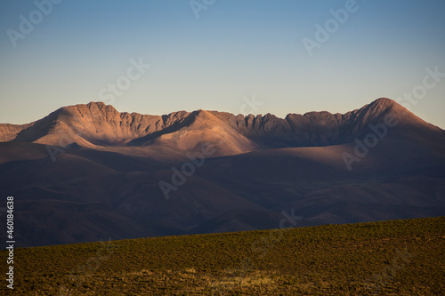 Crown shaped dry mountains at late afternoon with last sunrays in Puna Argentina, near Yavi town. North Argentina
 photo