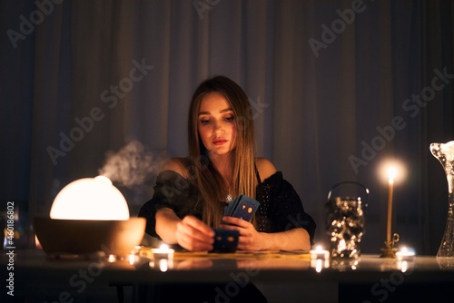 Woman reading tarot cards in spiritual room