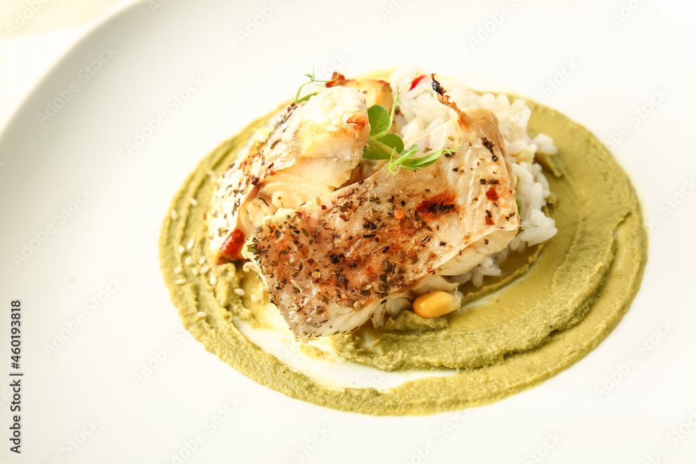 Plate with tasty baked cod fillet, rice and guacamole sauce, closeup Plate with tasty baked cod fillet, rice and guacamole sauce, closeup