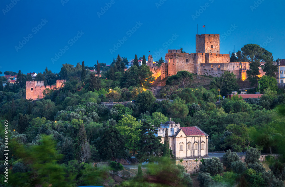 Beautiful landscape of Tomar Castle at dusk, with the Chapel of Nossa Senhora da Conceição at the bottom, in the city of Tomar, Portugal.