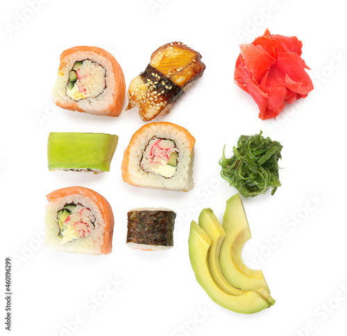 Different sushi, rolls, ginger, chukka and sliced avocado on white background